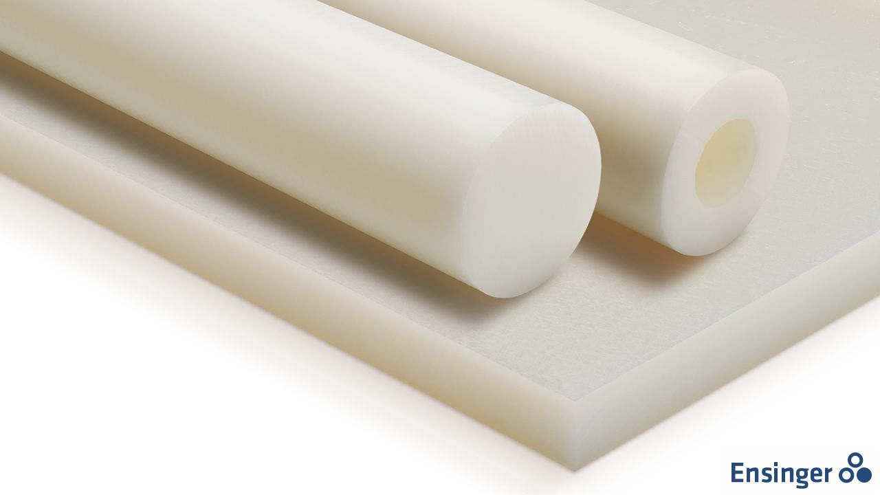 Two white plastic rods of different diameters, possibly made of extruded nylon 6, lying on a white plastic sheet.
