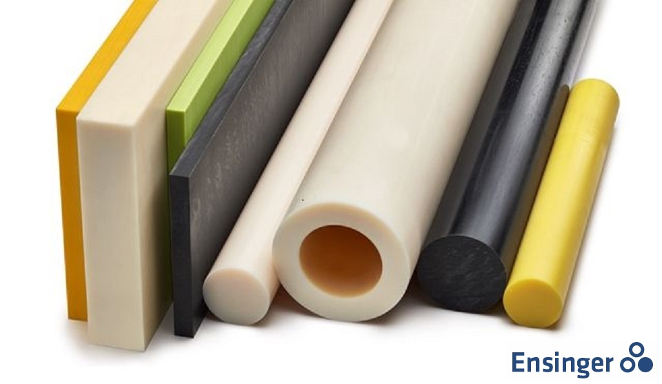 A close-up photo of a variety of colorful plastic rods and sheets, stacked on a white background.