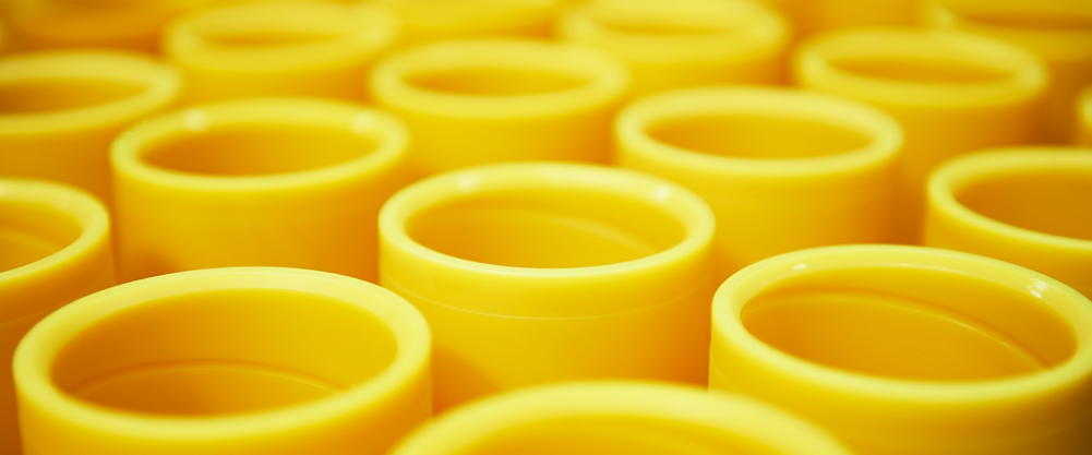 Close-up of several yellow plastic cups.