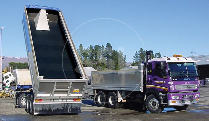 A large truck with a trailer parked alongside another.