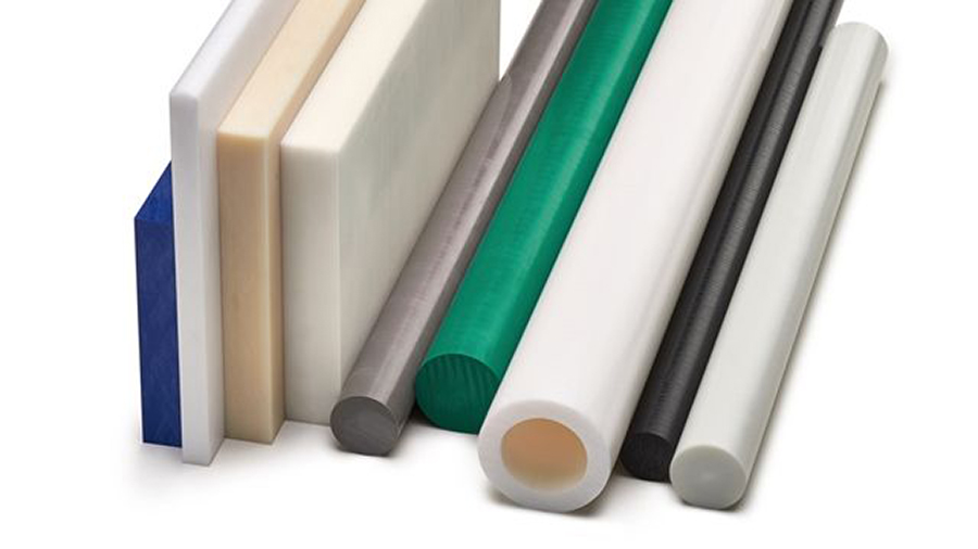 A stack of acetal plastic sheets and rods of various sizes.