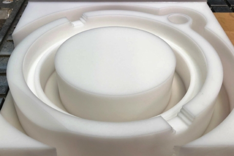 Acetal plastic cut to shape for food production equipment.