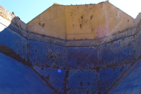 A close-up worn and rust truck bed.