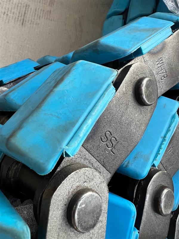 Blue Polyurethane capped chains grip product on the line without causing damage.