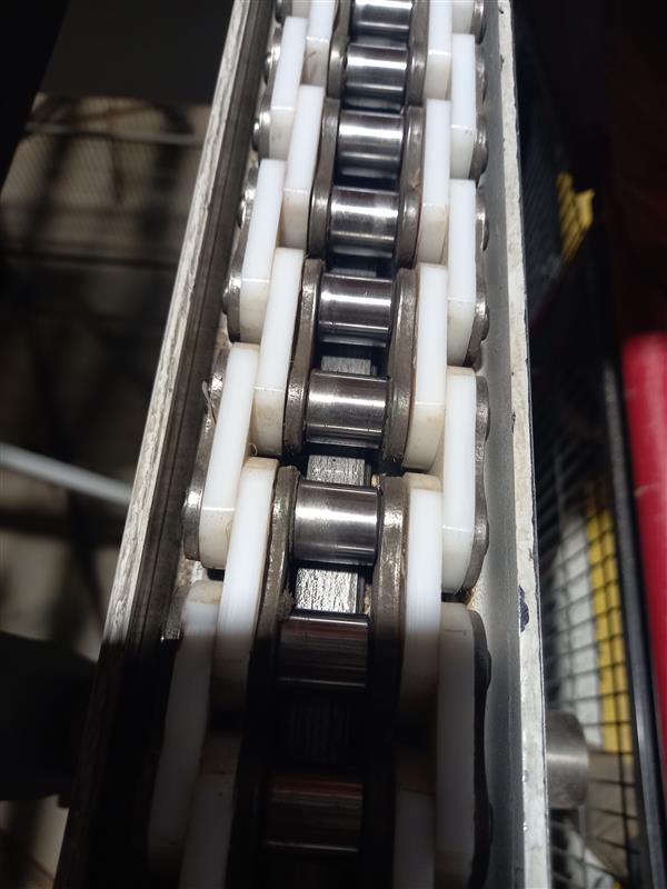 A chain fitted with a protective plastic plate between the inner and outer links.